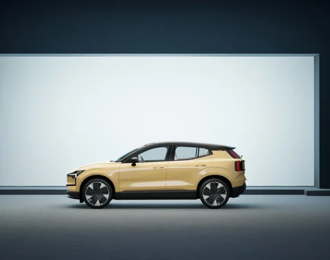 Gold Volvo under contrasting studio lighting — view 1