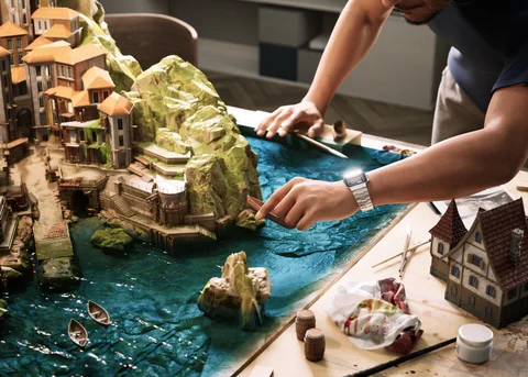 A man detailing a miniature village — view 3