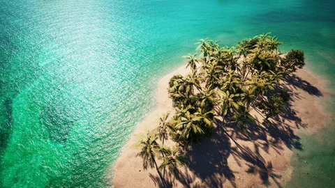 Palm-covered islands in turquoise water — view 1