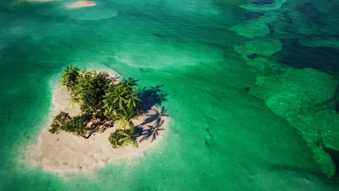 Palm-covered islands in turquoise water — view 2