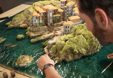 A man detailing a miniature village — view 5