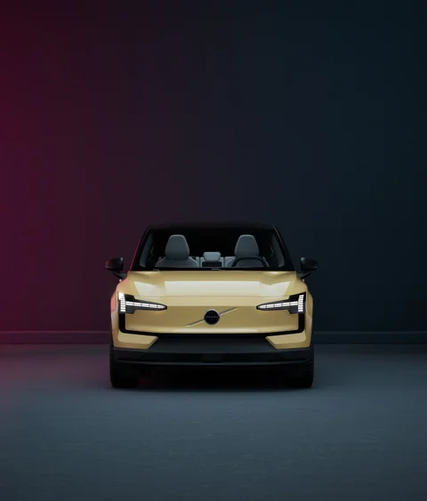 Gold Volvo under contrasting studio lighting — view 3