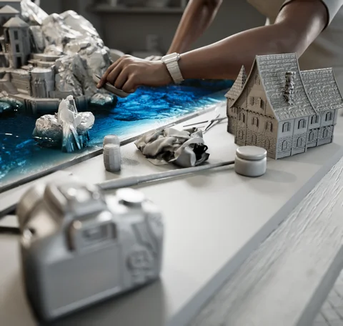Scene development: A man detailing a miniature village — view 6