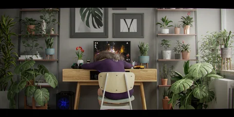 A plant-filled room under different lighting — view 1