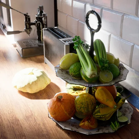 Sunlit kitchen with fruit and plants — view 2