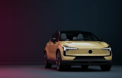 Gold Volvo under contrasting studio lighting — view 5
