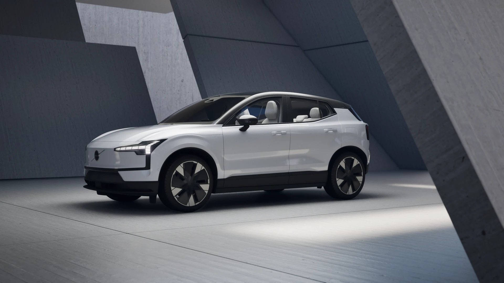 Silver vehicle framed by angular concrete architecture