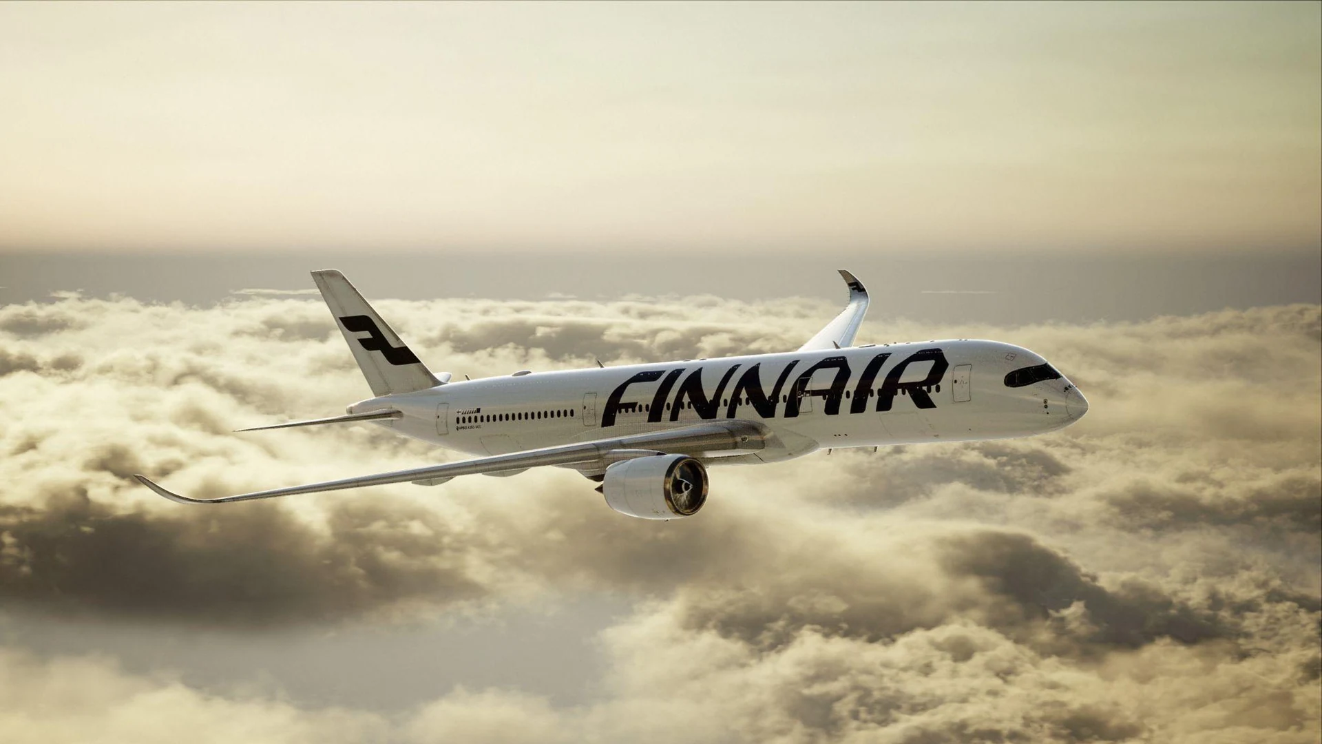 Finnair aircraft flying above a sunlit cloud layer