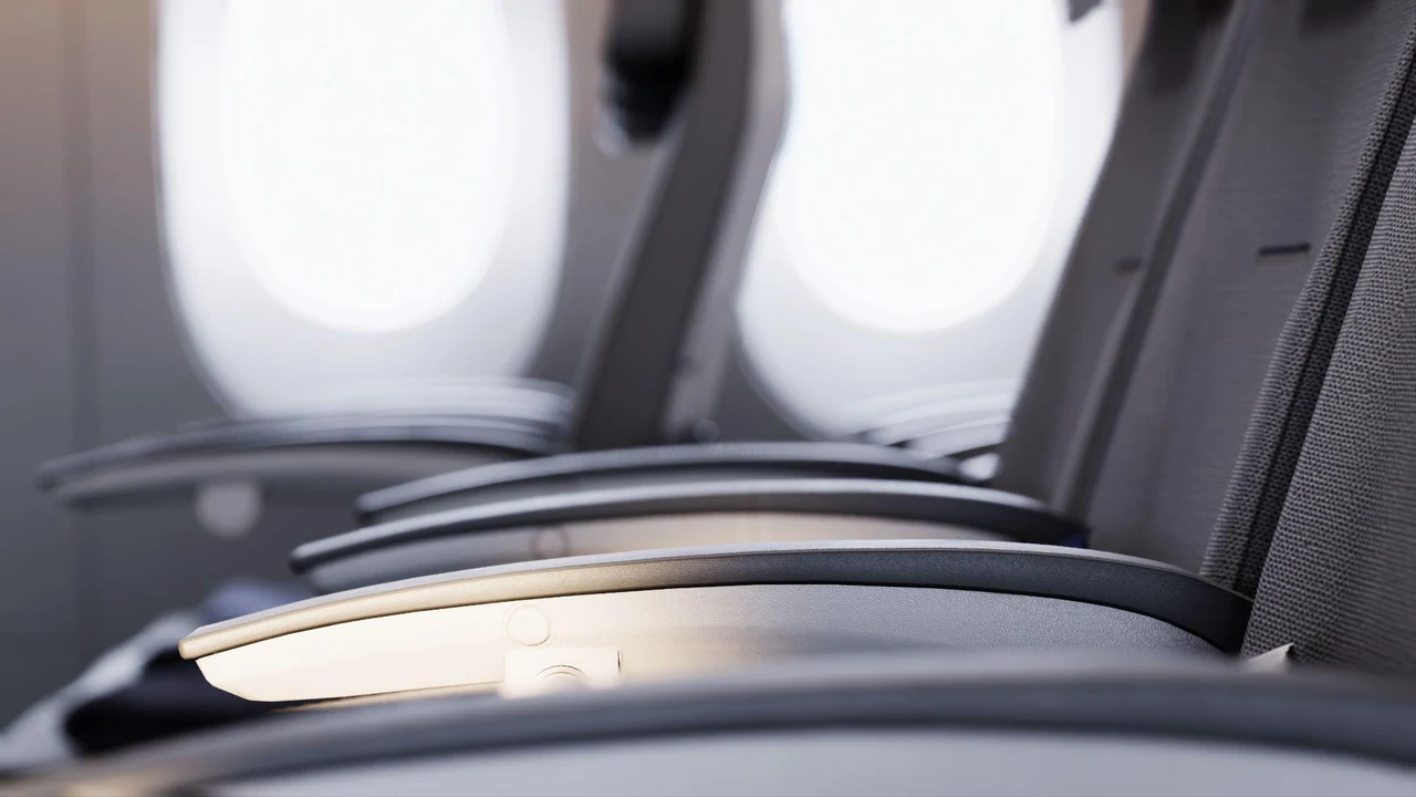 Aircraft seat armrests illuminated by window light