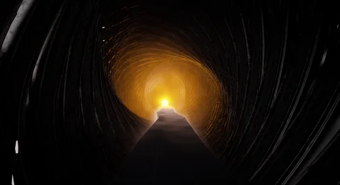 Golden light at the end of a deep cylindrical chamber