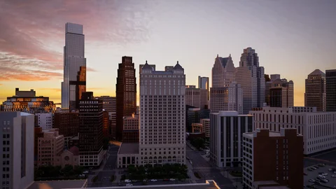 City skyline beneath a pink evening sky