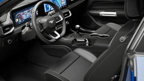 Vehicle cabin with dark upholstery and a digital dashboard