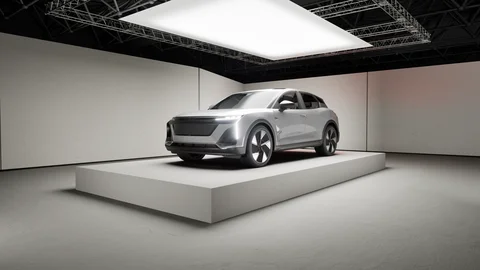 Silver vehicle beneath a large studio light