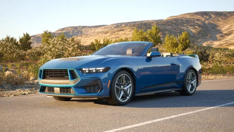 Blue convertible on a sunlit country road