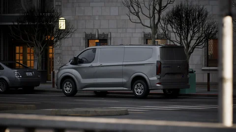 Grey van parked outside a city building