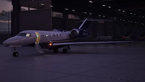Business jet in a dimly lit hangar