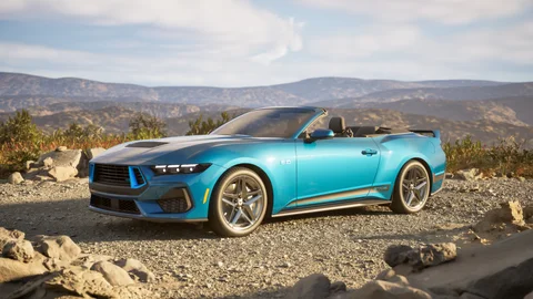 Turquoise convertible in a rocky landscape