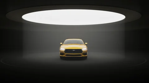 Yellow car beneath a circular studio light
