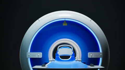 Blue-lit medical scanner seen from the front