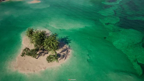 Small tropical island surrounded by shallow water
