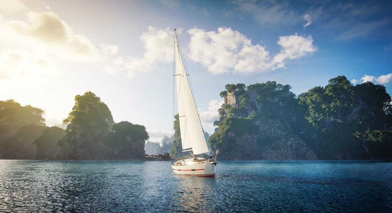 Sailing boat beside tropical limestone cliffs