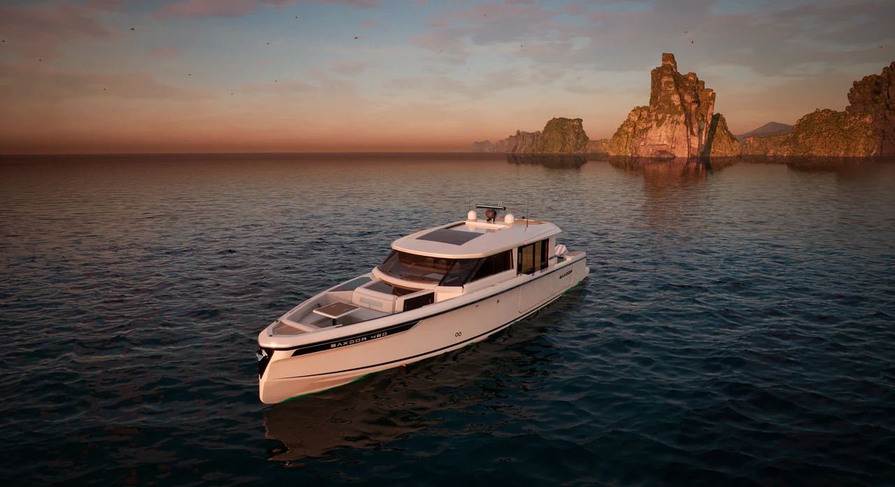 Motor yacht against coastal cliffs at sunset